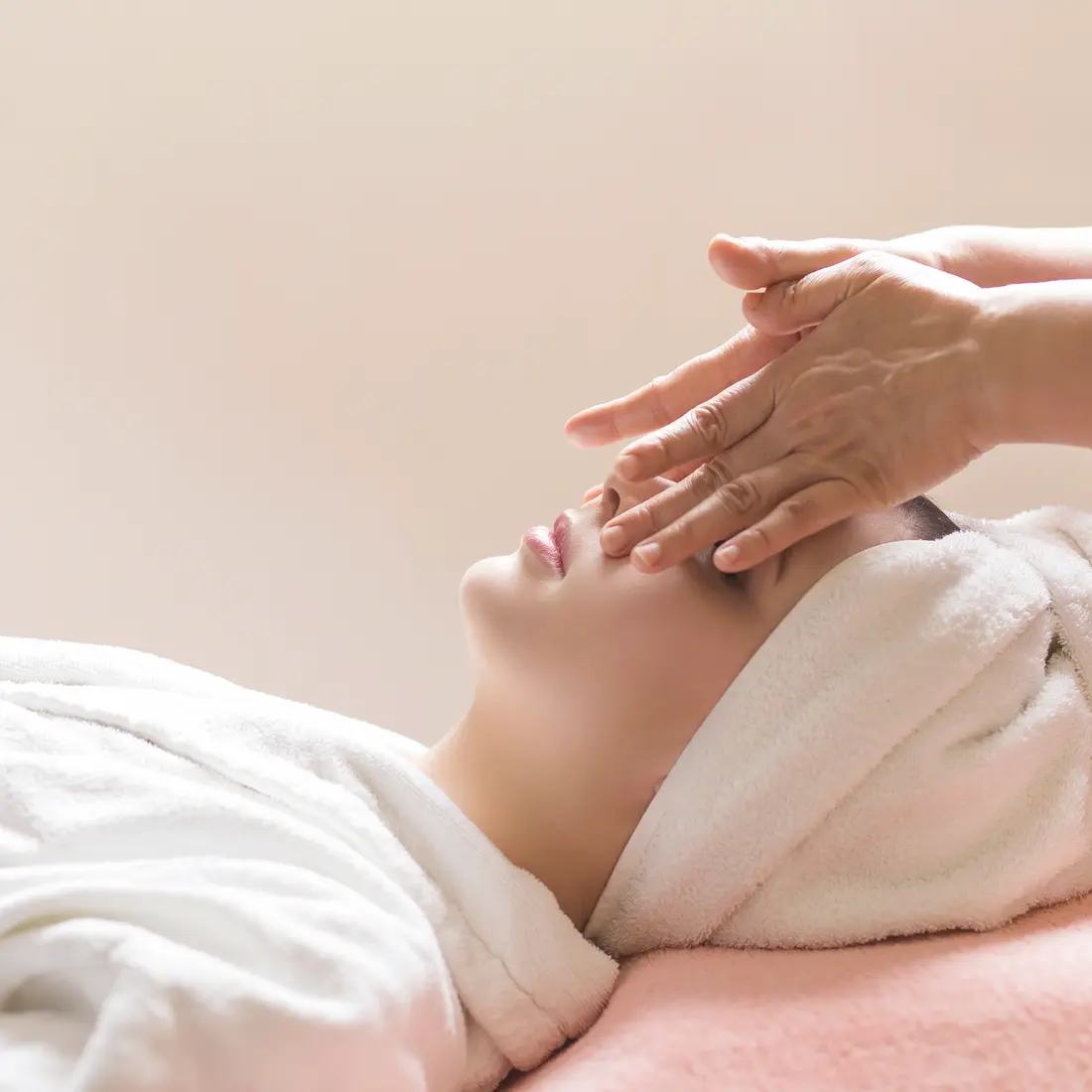 woman receiving a facial massage in a spa