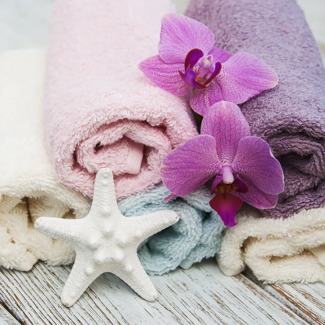 rolled spa towels with orchids and starfish