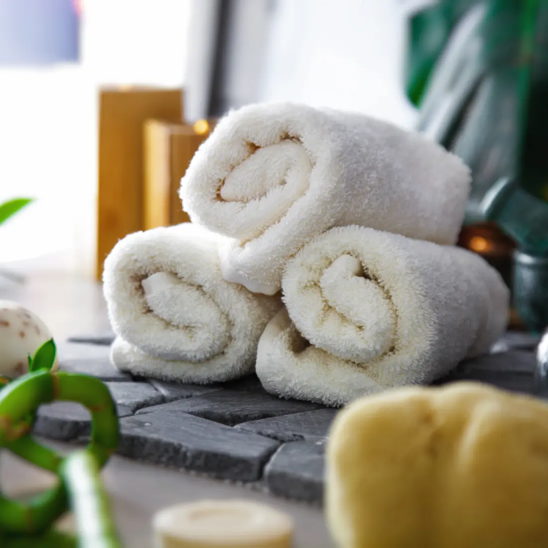 rolled white towels with spa accessories
