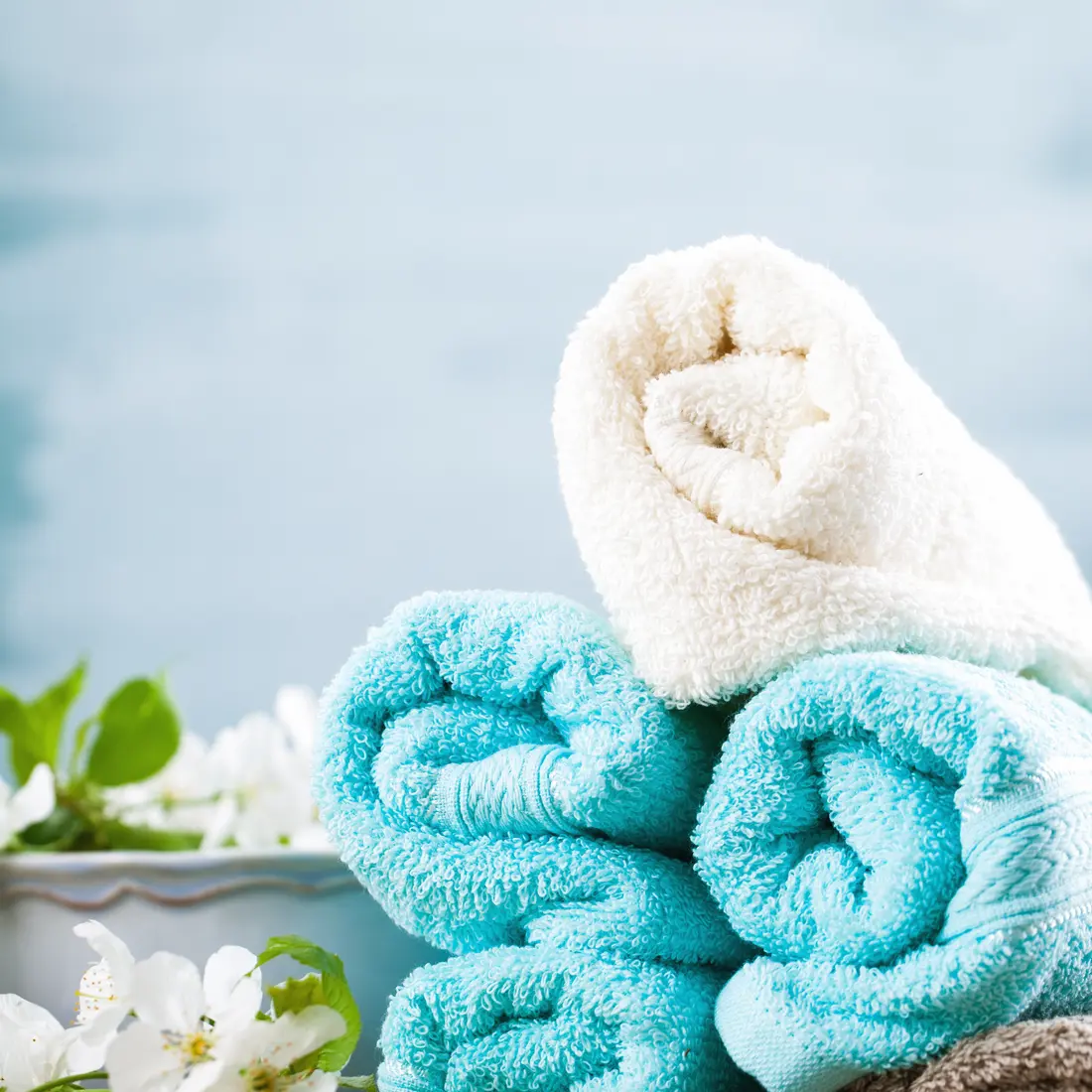 rolled spa towels with white flowers