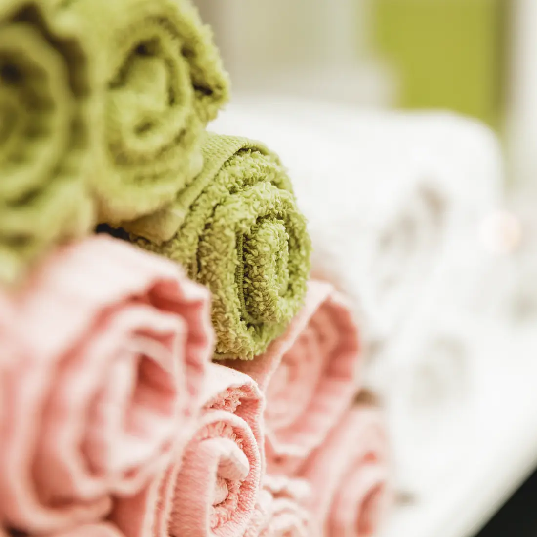 rolled spa towels in pink and green