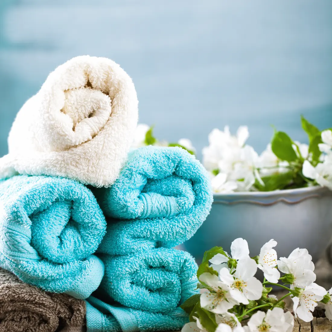 rolled spa towels with white flowers