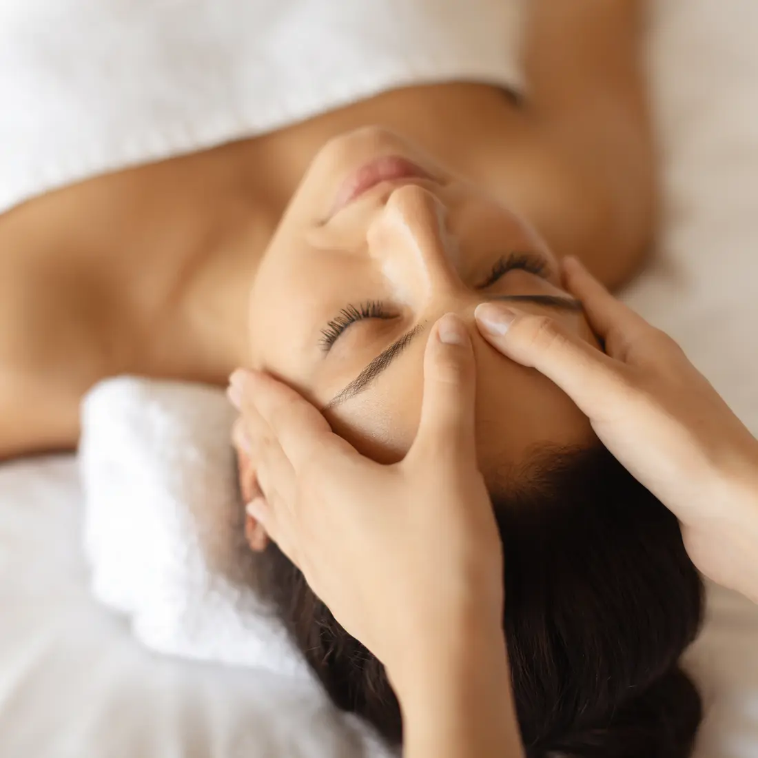 woman receiving a relaxing facial massage