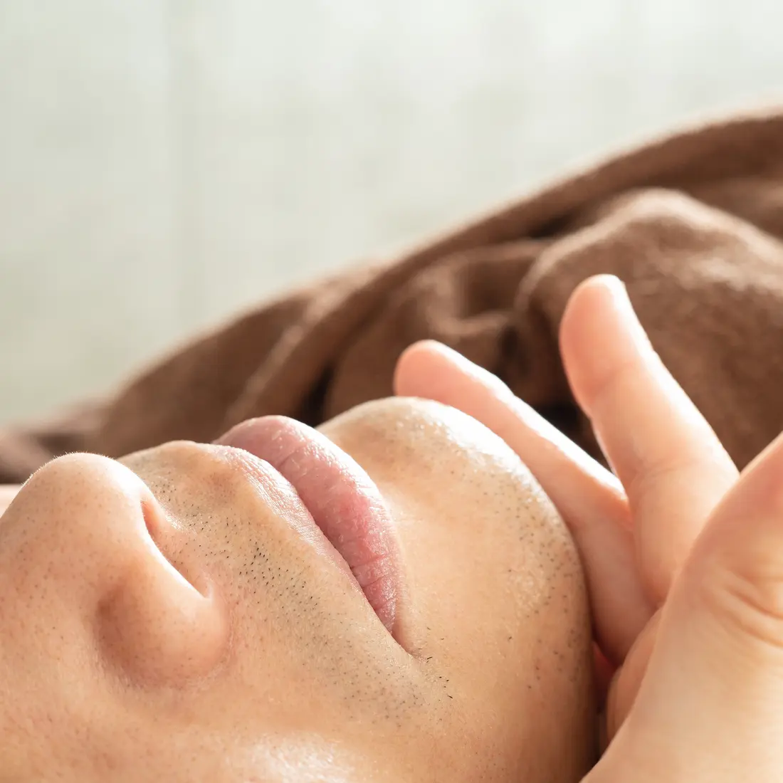 close-up of a person receiving a facial massage