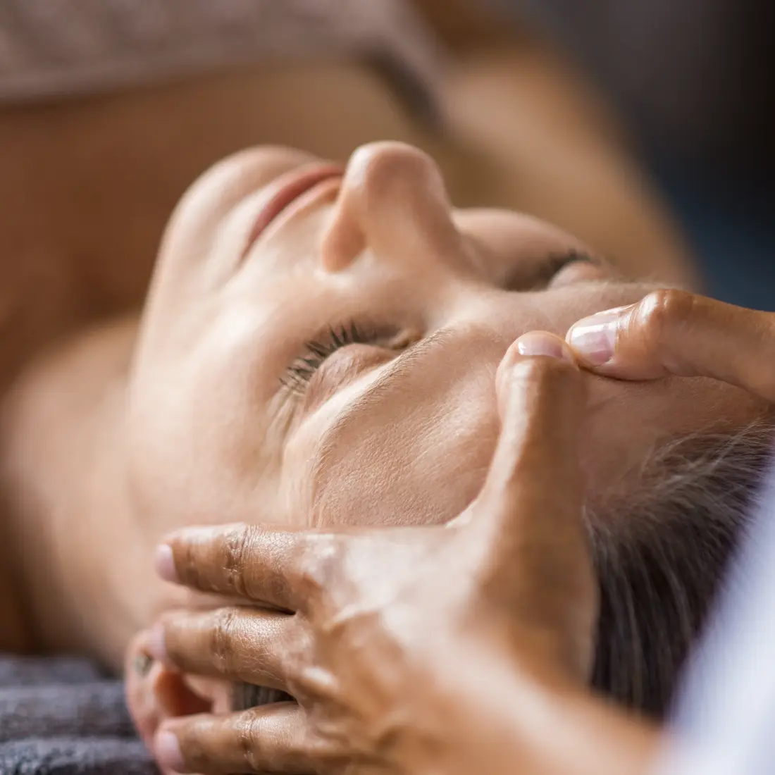 close up of a woman receiving a facial massage