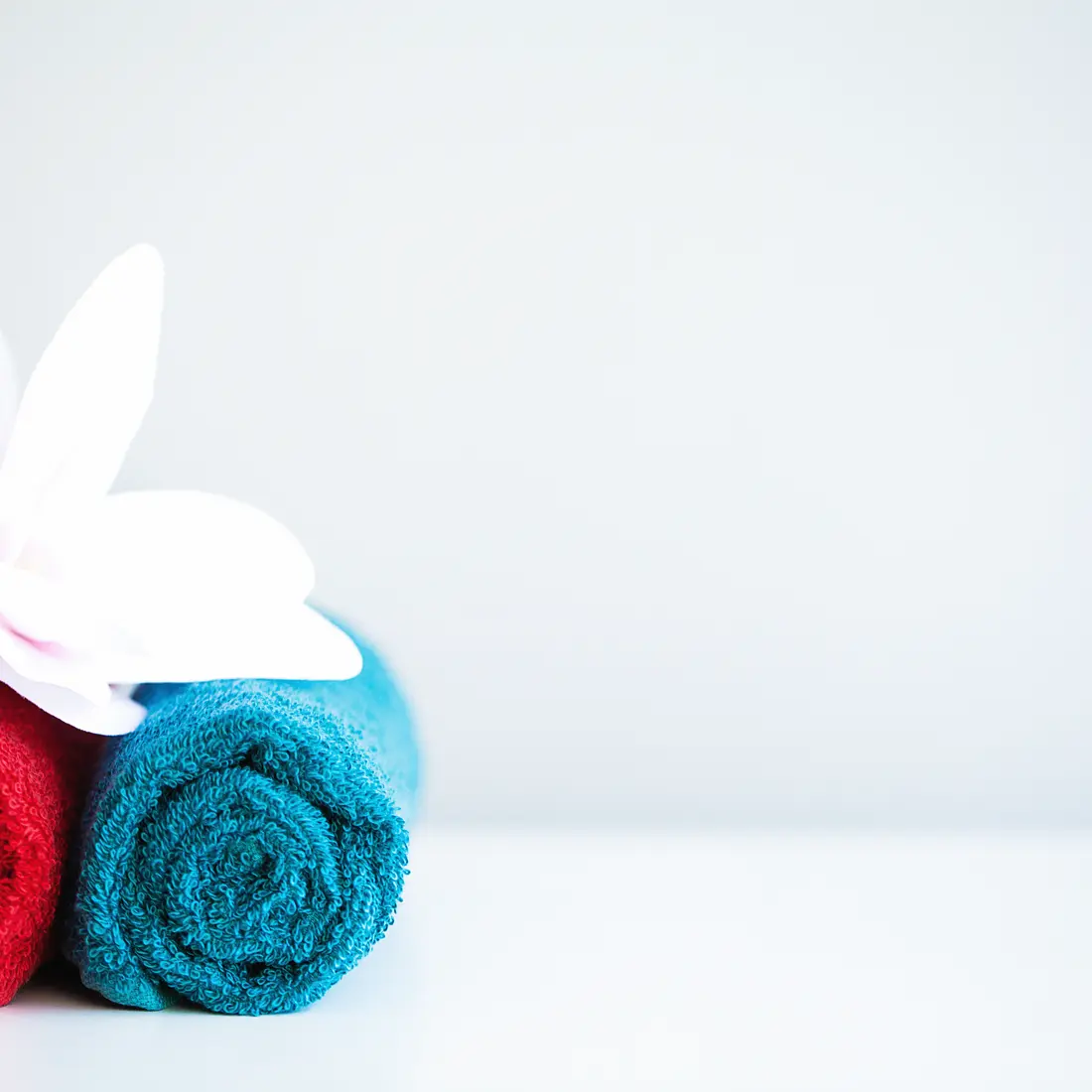 rolled towels with a flower decoration