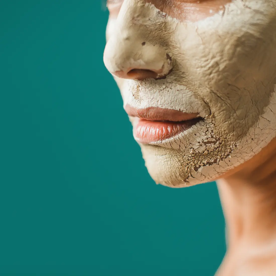 close up of adult face with clay mask