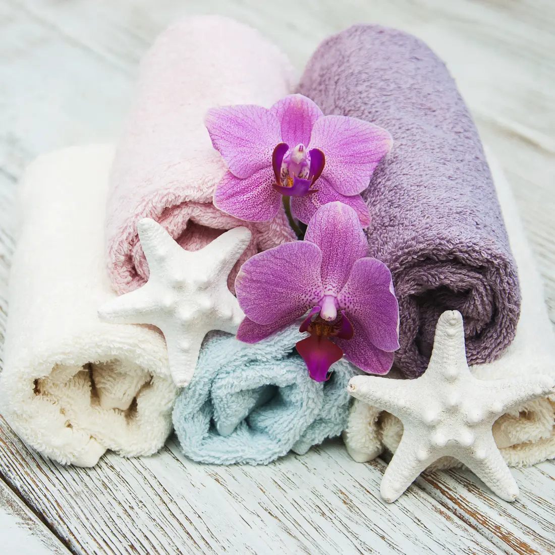 rolled towels with orchids and starfish