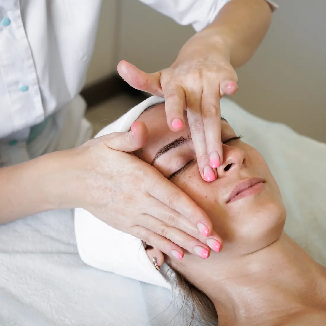 esthetician giving woman a facial massage