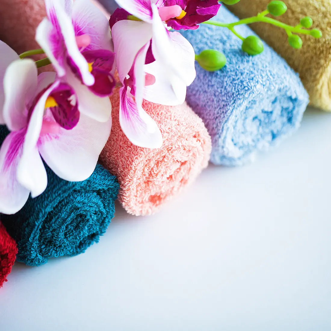 rolled towels with orchids and buds